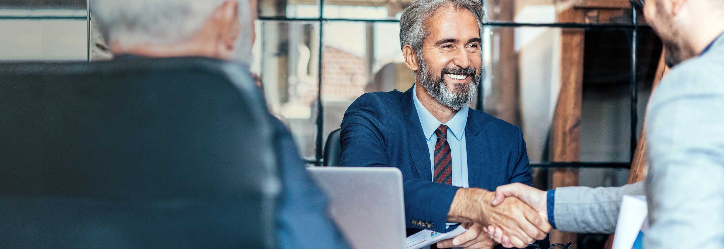 Commercial bankers shaking hands in a meeting